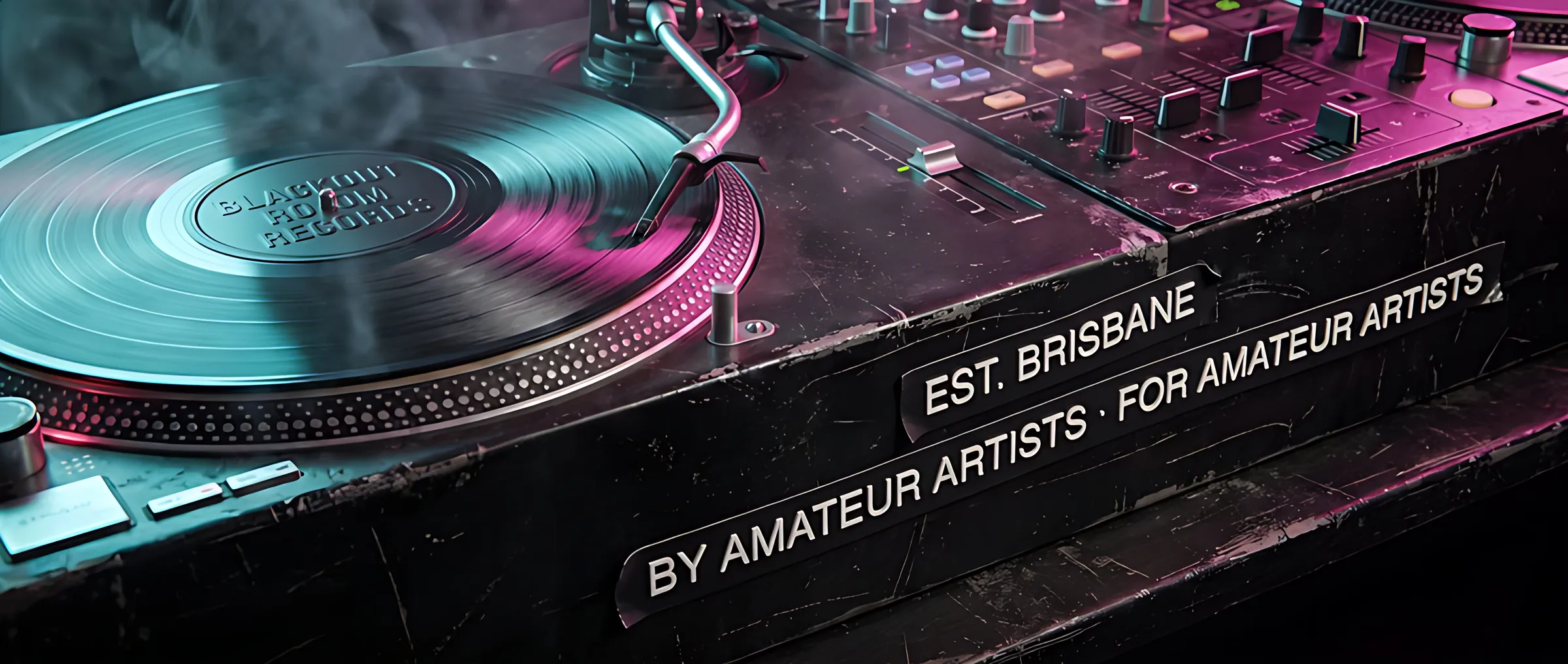 Decks and mixer under cyan and magenta light, label tape reading Est. Brisbane and By amateur artists for amateur artists